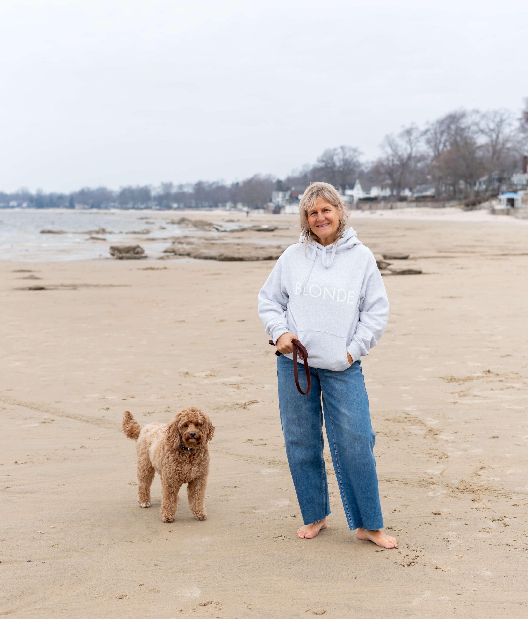 Karen Roy on a beach with her dog
